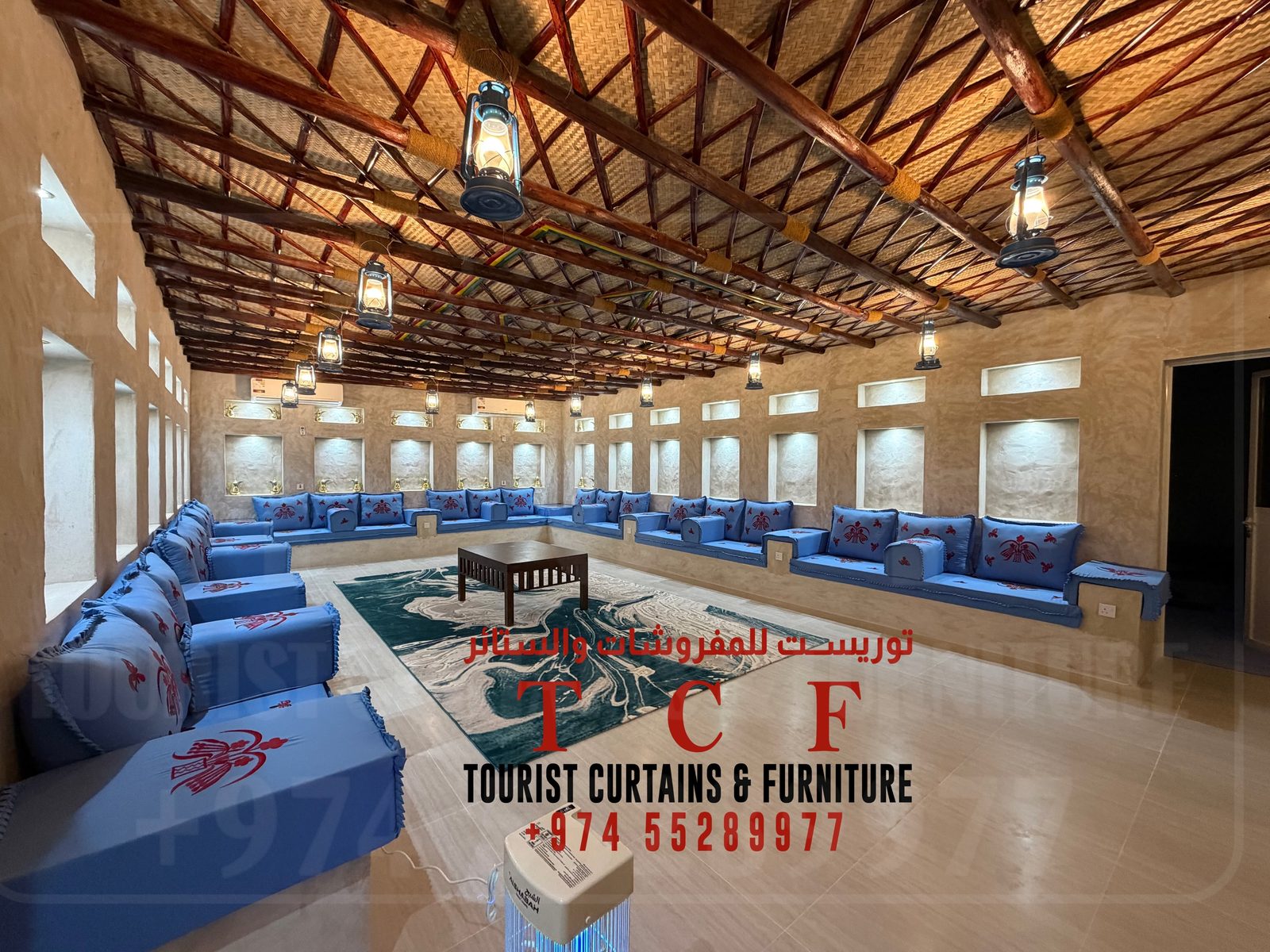 Grand majlis interior by Tourist Furniture with carved wooden beam ceiling